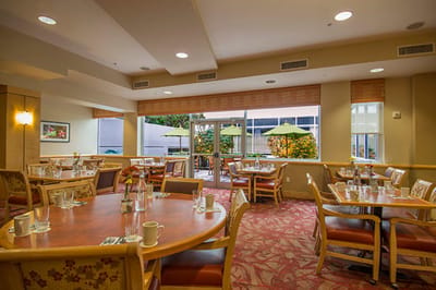 Bright dining room with tables and outdoor view