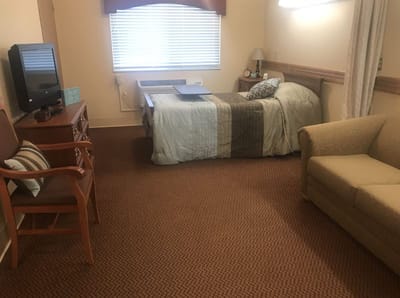Private resident room with bed and furniture