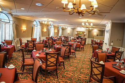 Bright dining room with tables set for meals