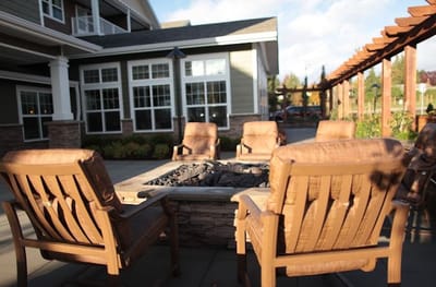 Outdoor seating area with chairs around a fire pit