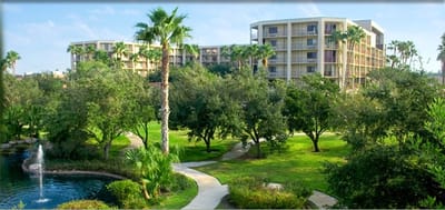 Exterior view of Golden Palms Retirement Center surrounded by greenery