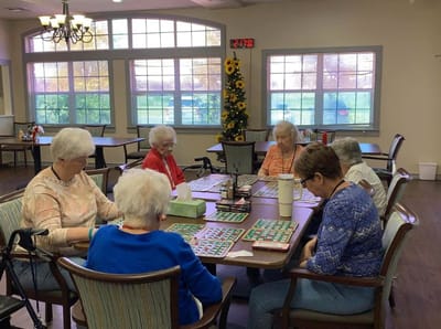 Residents engaged in a bingo game in activity room