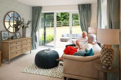 Residents enjoying conversation in a cozy lounge area