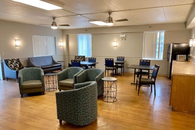 Bright common area with seating and tables