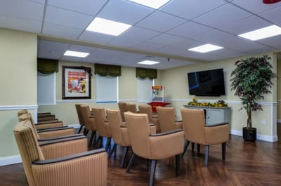 A neat common area with chairs arranged for a meeting