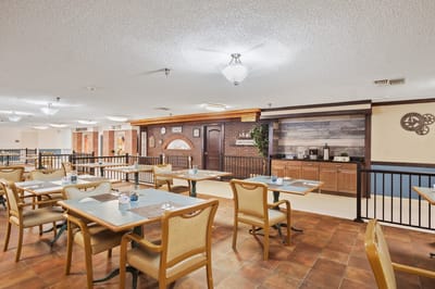 Dining area with tables and chairs in a cozy setting