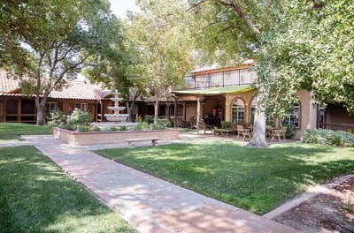 A peaceful outdoor space with a fountain and seating