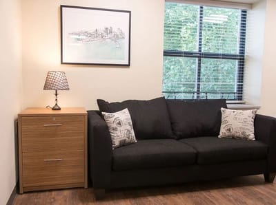 Cozy living room setup with a sofa and lamp