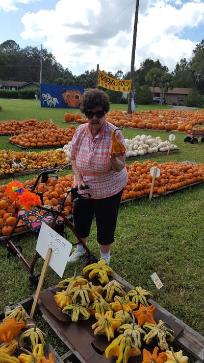 Resident enjoying a pumpkin patch activity outdoors