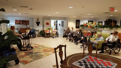 Residents enjoying a live music performance in a common area