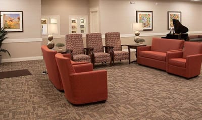 Cozy common area with seating and piano.