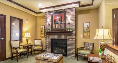 Cozy seating area with a fireplace in the facility