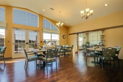 Dining area with tables and chairs in a bright setting