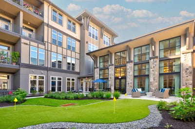 Exterior view of a senior living facility with landscaped garden