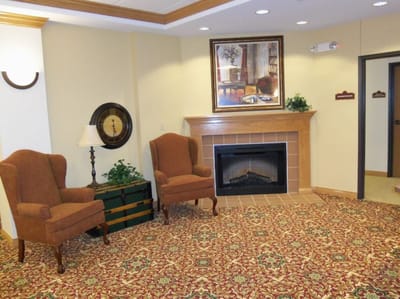 Cozy common area with chairs and fireplace