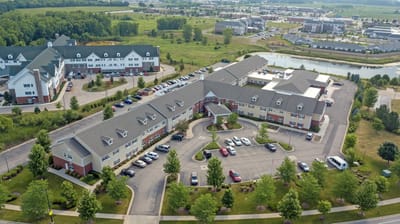 Aerial view of a senior living facility with surrounding landscape