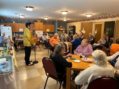 Residents enjoying an entertainment event with a performer