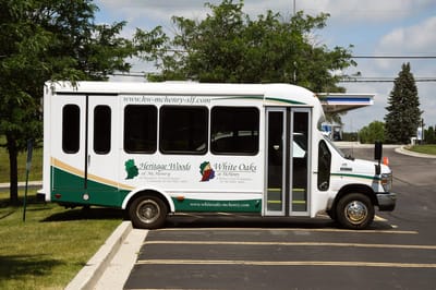 Facility transport van parked in the lot.