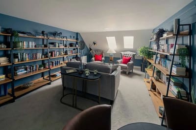 Comfortable common area with bookshelves and seating