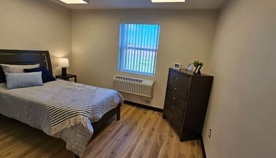 Cozy private room with a bed and dresser
