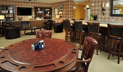 Common area with seating and a bar in a cozy lounge