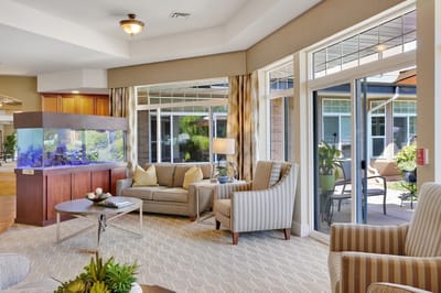 Bright common area with comfortable seating and aquarium