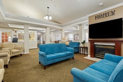 Cozy common area with blue sofas and fireplace