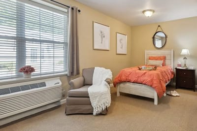 Cozy private resident room with bed and chair