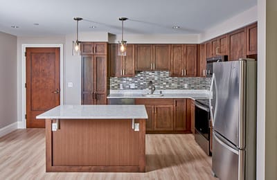 Modern kitchen interior with brown cabinetry and appliances