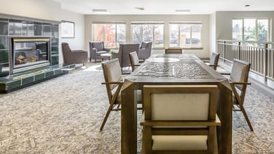 Bright common area with seating and fireplace
