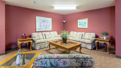 Cozy common area with floral sofas and artwork
