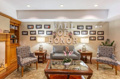 Cozy common area with chairs and a wall of honor