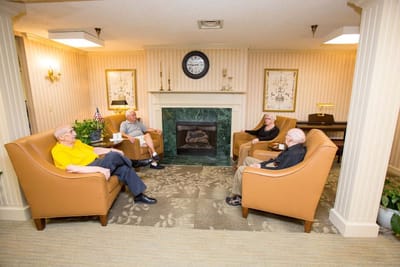 Residents relaxing in a common area of the facility