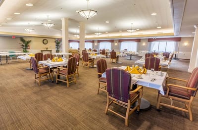 Dining room with tables set for residents