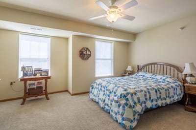 Bright resident room with a quilted bedspread