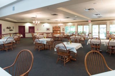 Bright dining room with tables and wooden chairs