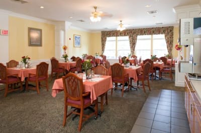 Dining area with neatly set tables and flowers