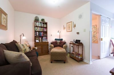 Cozy resident room with a couch and bookshelf