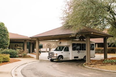 Facility entrance with shuttle bus under porte-cochère