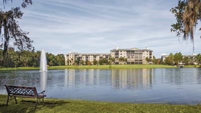 Exterior view of the Lake Port Square facility by a serene lake