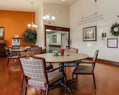 Common area with tables and chairs in a senior living facility