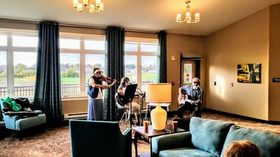 Musicians performing in a common area with residents