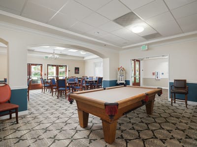 Bright interior common area with pool table and dining space