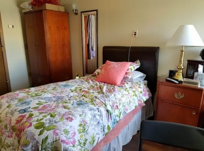 Cozy resident room with floral bedding and simple decor