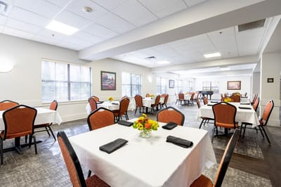 Bright dining room with tables set for meals