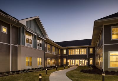 Exterior view of Legacy Village at dusk with pathway