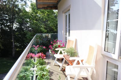 Balcony with chairs and potted flowers