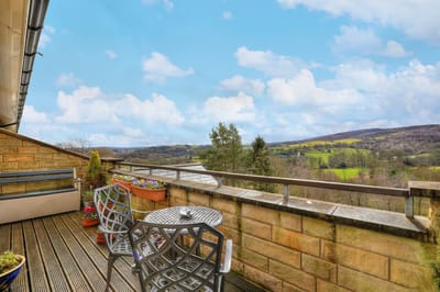 Scenic outdoor balcony with chairs and plants