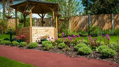 Well-maintained garden with flowers and a gazebo