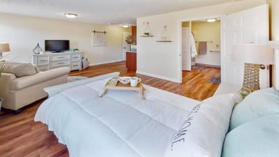 A bright interior of a resident room with furniture